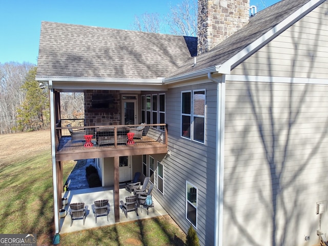 back of property with a patio and a lawn