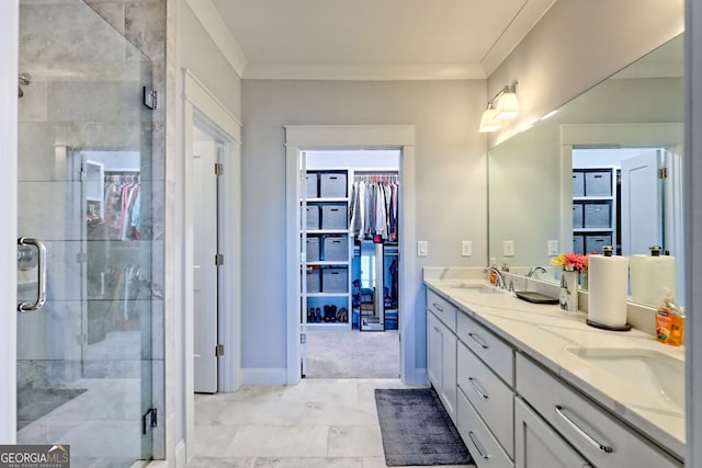 bathroom with vanity, crown molding, and walk in shower