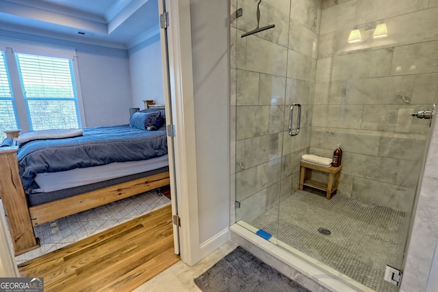 bathroom featuring a shower with door and ornamental molding