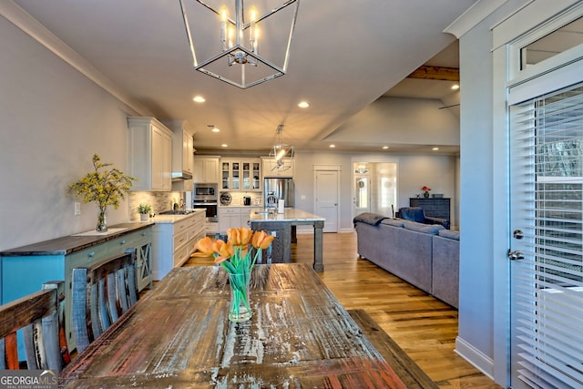 dining room with sink and light hardwood / wood-style floors