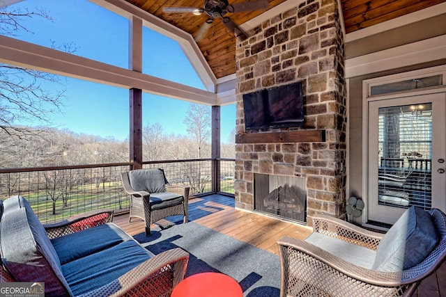 interior space featuring ceiling fan and an outdoor stone fireplace