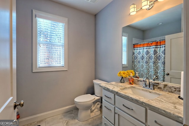 bathroom with vanity, toilet, and curtained shower