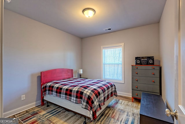 bedroom with hardwood / wood-style floors