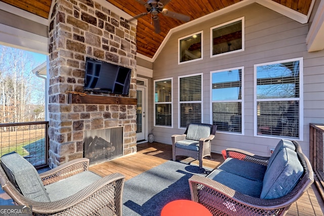 view of patio with ceiling fan and an outdoor stone fireplace