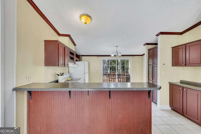 kitchen with ornamental molding, a breakfast bar, and kitchen peninsula