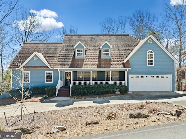 view of front of home featuring covered porch, an attached garage, and concrete driveway