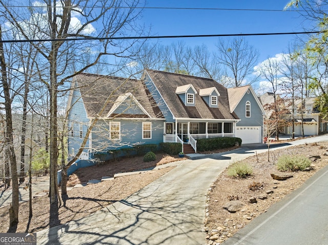 view of front of property featuring a garage, covered porch, roof with shingles, and concrete driveway