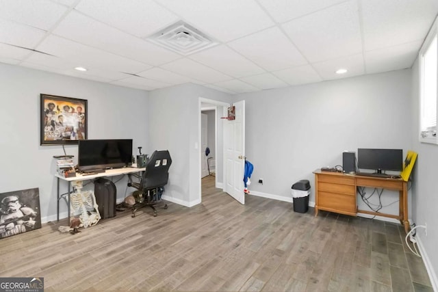 office with a paneled ceiling and wood-type flooring