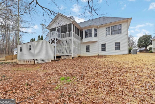 rear view of property with a sunroom and central air condition unit