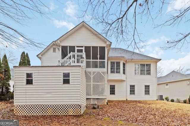 rear view of property with a sunroom and central AC