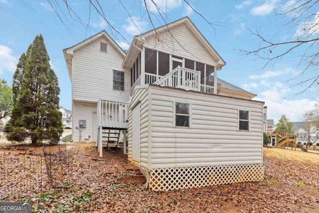 back of property with a sunroom