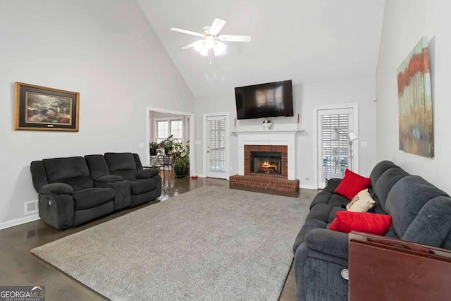 living room with ceiling fan, a fireplace, and high vaulted ceiling