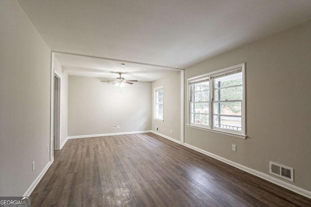 unfurnished room featuring dark wood-type flooring and ceiling fan