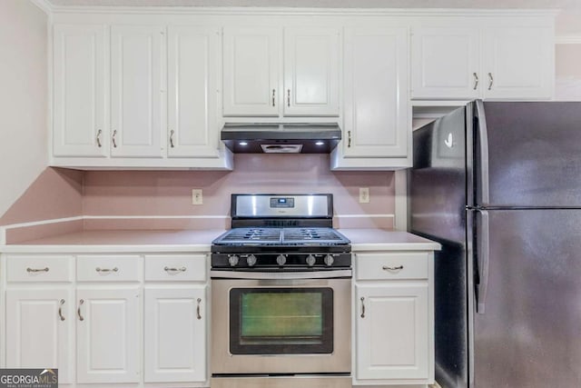 kitchen with stainless steel range with gas cooktop, ventilation hood, white cabinets, and black fridge