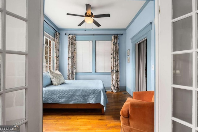 bedroom featuring light wood-type flooring and crown molding