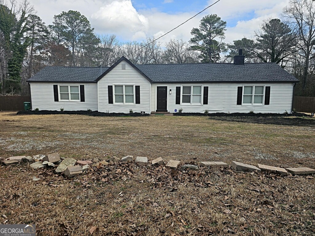 3930 W Side Pl, Ellenwood, GA 30294 - ranch-style home with a shingled roof, a chimney, and a front lawn