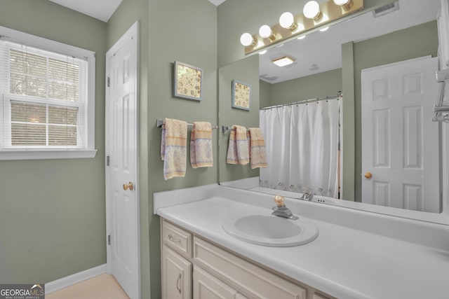full bathroom featuring vanity and baseboards