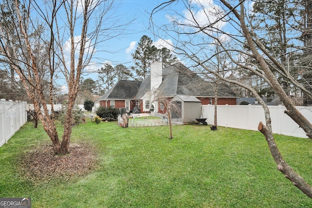 view of yard featuring a storage shed and an outdoor structure
