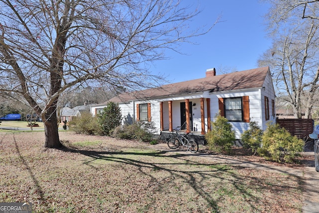 view of front of property featuring a porch and a chimney