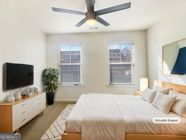 bedroom with multiple windows and ceiling fan