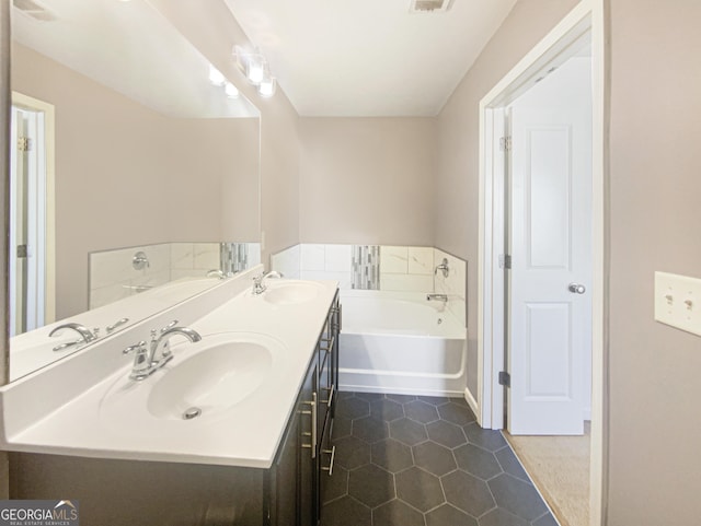 bathroom featuring vanity, a tub, and tile patterned floors