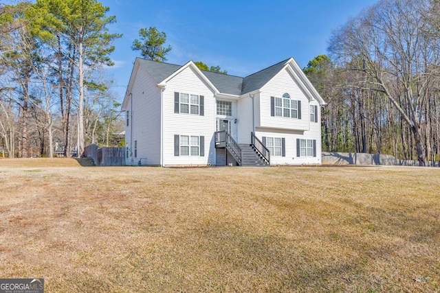 view of front of home featuring a front yard and fence