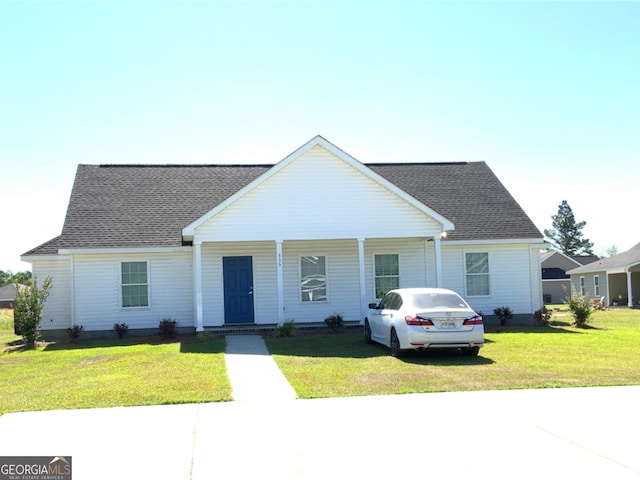 ranch-style house with covered porch and a front lawn