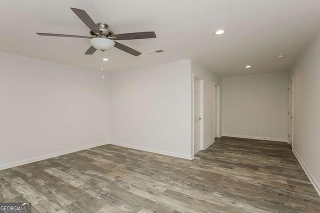 unfurnished room featuring ceiling fan and dark hardwood / wood-style floors