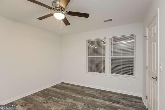 unfurnished room with dark hardwood / wood-style floors and ceiling fan