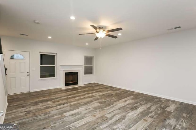 unfurnished living room with dark wood-type flooring and ceiling fan