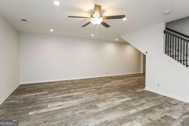 spare room featuring ceiling fan and dark hardwood / wood-style flooring