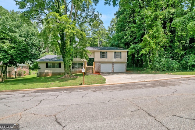 view of front of house with a garage and a front lawn