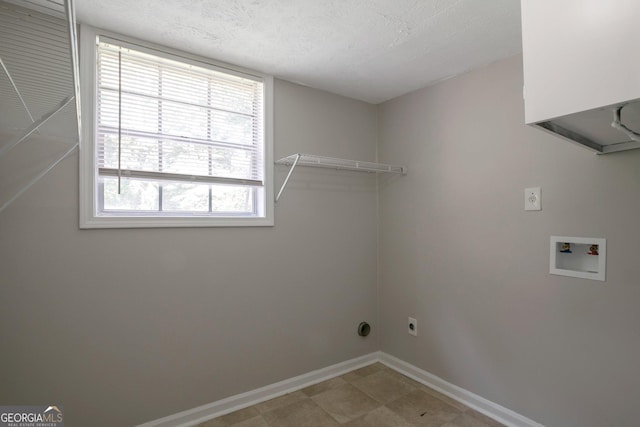 clothes washing area with washer hookup, hookup for an electric dryer, and a textured ceiling