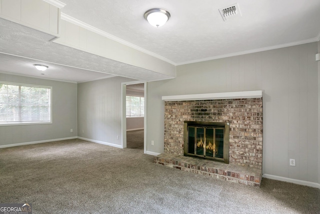 unfurnished living room featuring crown molding, a brick fireplace, a healthy amount of sunlight, and carpet flooring