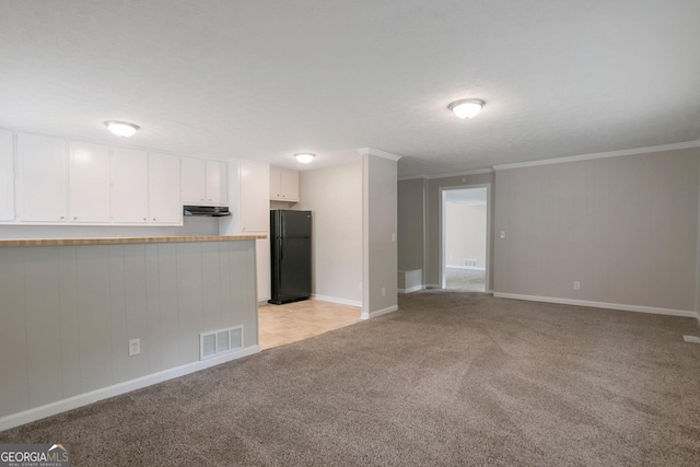 unfurnished living room featuring crown molding and light carpet