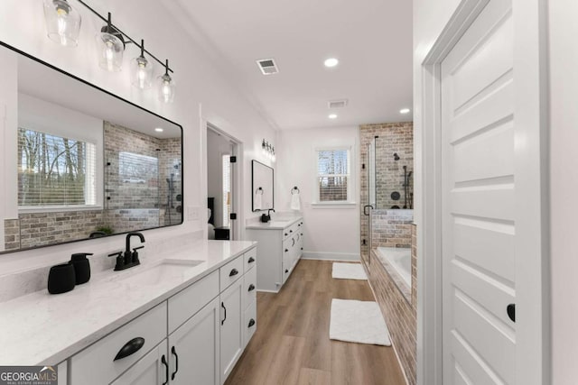 bathroom featuring vanity, wood-type flooring, separate shower and tub, and plenty of natural light