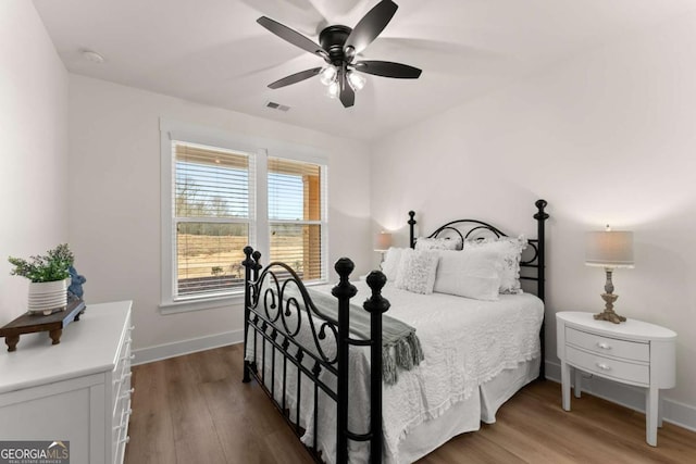 bedroom featuring dark wood-type flooring and ceiling fan