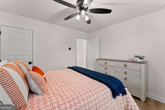 bedroom featuring dark hardwood / wood-style flooring and ceiling fan