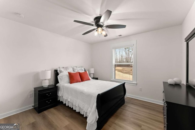 bedroom with wood-type flooring and ceiling fan