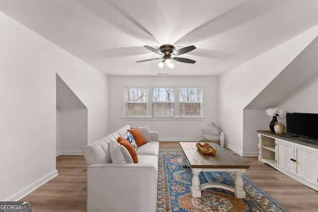 living room featuring hardwood / wood-style flooring and ceiling fan