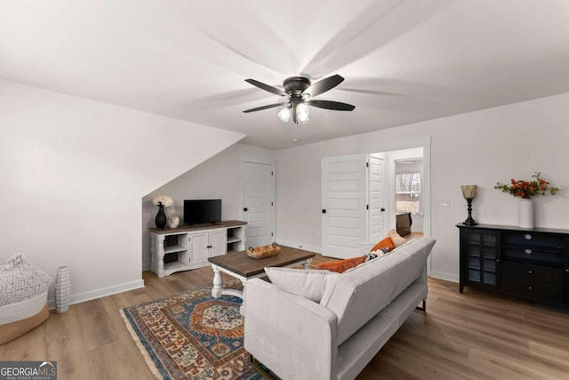 living room with hardwood / wood-style flooring and ceiling fan