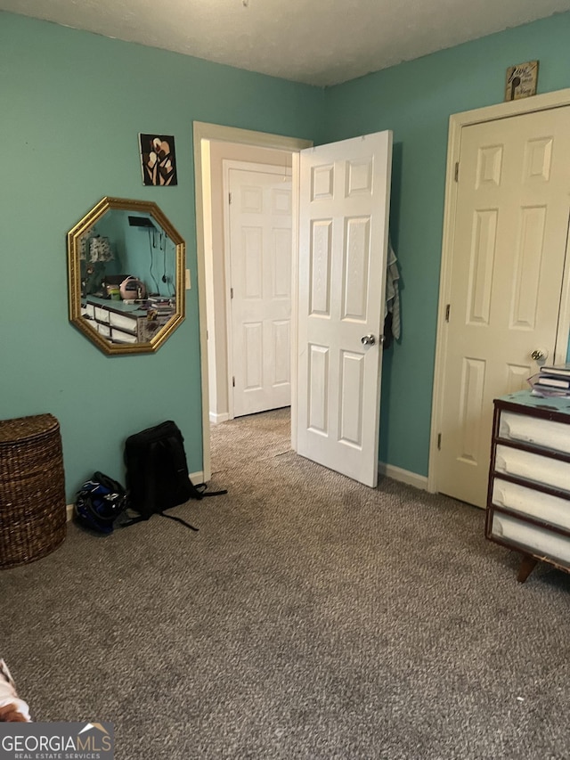 bedroom with carpet and baseboards