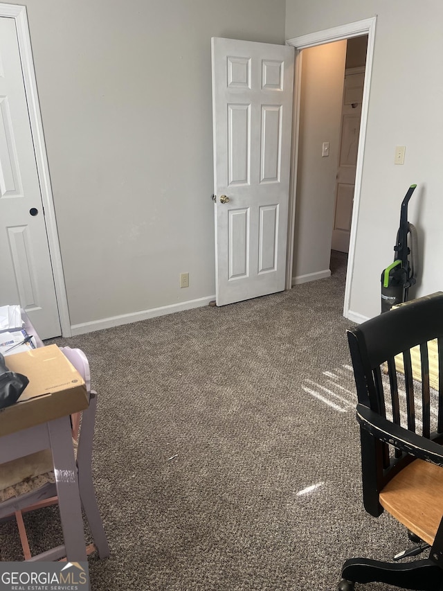 bedroom featuring carpet and baseboards