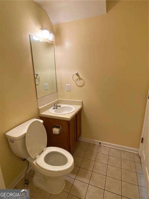 bathroom with vanity, tile patterned floors, and toilet