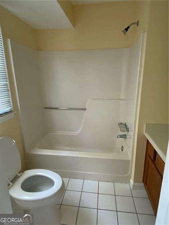 full bathroom featuring vanity, tile patterned floors, toilet, and shower / bath combination