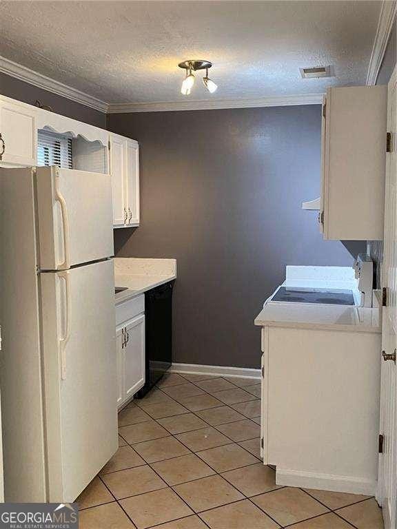 kitchen with crown molding, light tile patterned floors, white refrigerator, dishwasher, and white cabinets