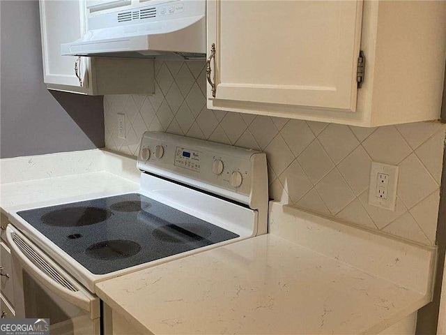 kitchen with backsplash and white range with electric stovetop