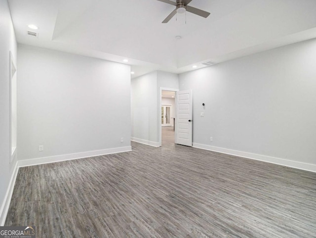 empty room featuring ceiling fan and dark hardwood / wood-style flooring