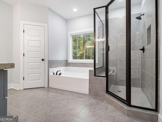 bathroom featuring separate shower and tub and tile patterned flooring