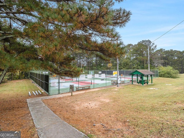 view of sport court with a yard